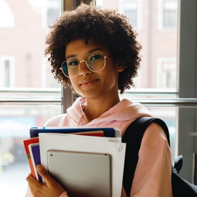 student with books and tablet