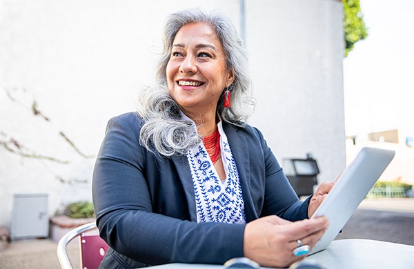 Smiling educator holding a tablet