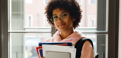 high school aged girl holding books