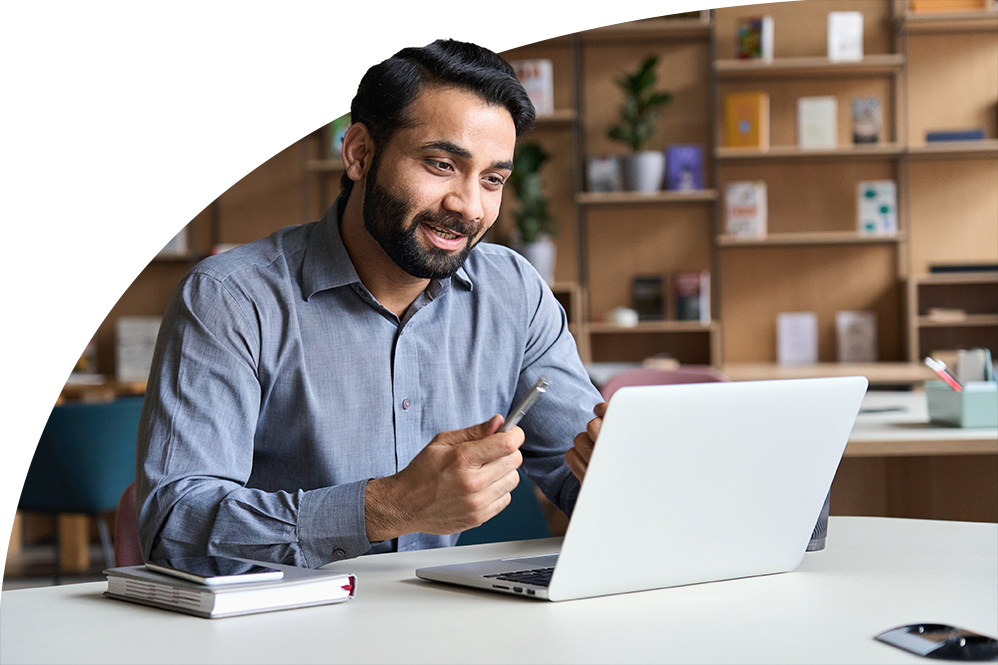 Instructor smiling and speaking into a laptop